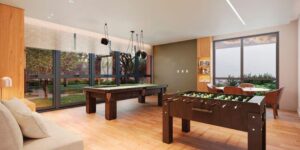 Salão de Jogos dentro do condomínio Reserva Ubiatans, com belo jardim de frente. Está com mesas, sofás, mesa de bilhar e ping bolling